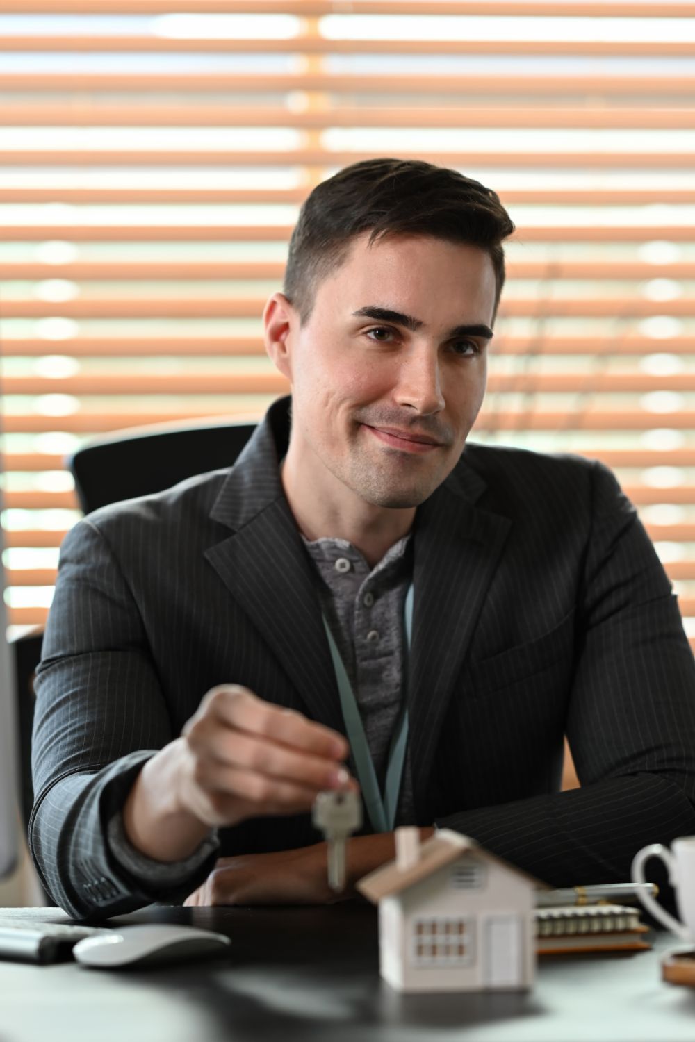 handsome businessman holding house keys and smilin xf68qwu.jpg